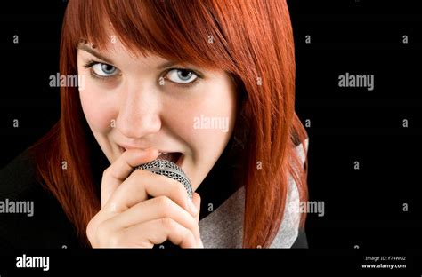 Girl singing karaoke on microphone Stock Photo - Alamy