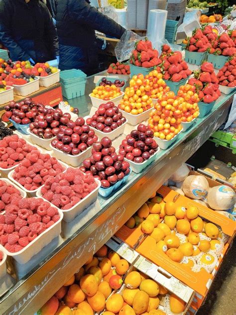 fruit stand  full  oranges raspberries   fruits