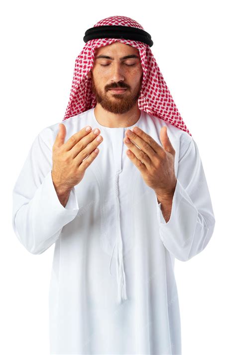 Premium Photo | Young Arab man in traditional clothing praying on white