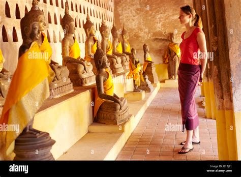 woman admiring ornate statues  temple stock photo alamy