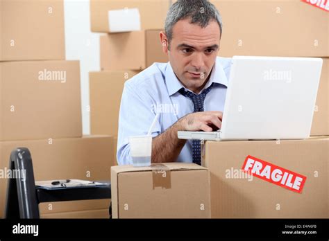 man surrounded  boxes stock photo alamy