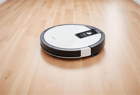 robot robot sits   wooden floor premium ai generated image
