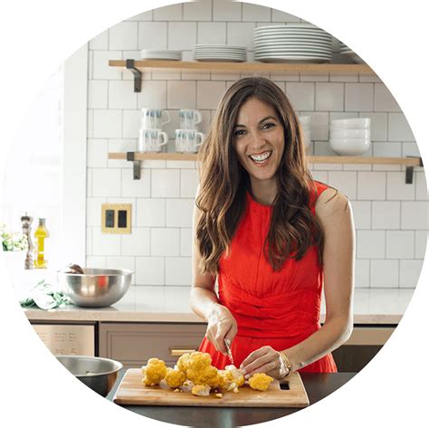 Download Smiling Woman Cookingin Kitchen | Wallpapers.com