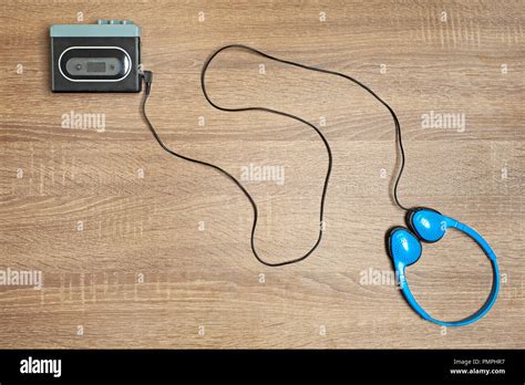 Retro walkman and blue headphones on the wooden brown background Stock Photo - Alamy