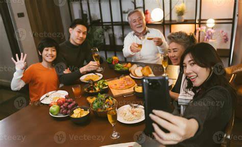 Asian family having taking selfie before dinner at dining table at home