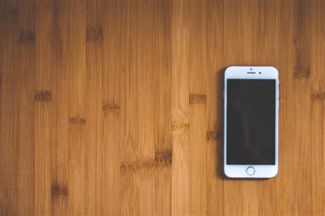 picture white mobile phone wood desk