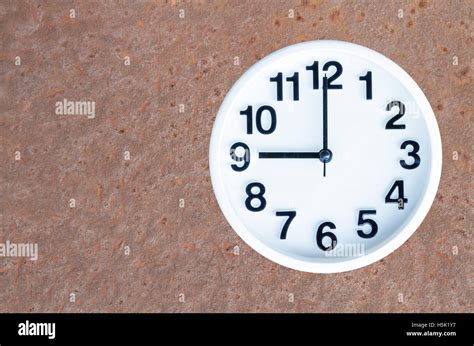 Clock show 9 am or pm on steel rusty background with copy space ...