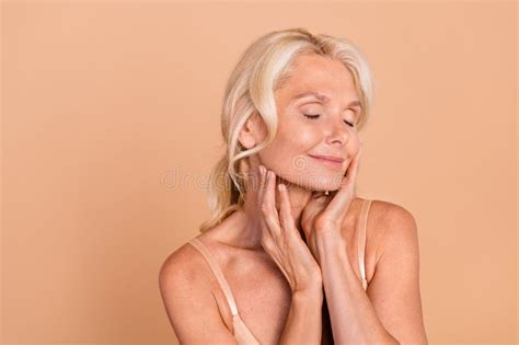 Photo of Dreamy Lovely Retired Lady with Closed Eyes Touch Moisturized ...