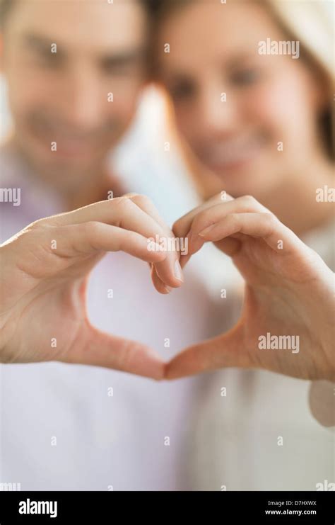 Couple making heart shape with hands Stock Photo - Alamy