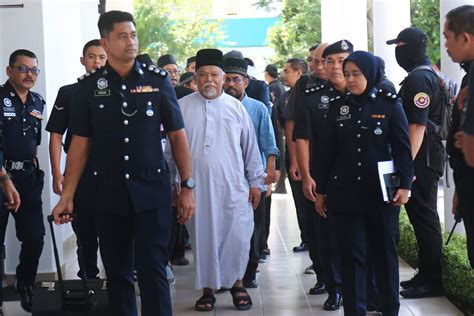Malaysia charges 22 members of an Islamic business group, including its
