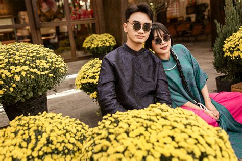 Traditional Vietnamese Couple Amidst Bright Blossoms · Free Stock Photo