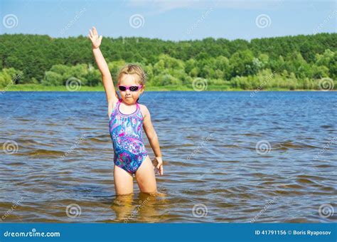 Little girl at river stock photo. Image of recreational - 41791156