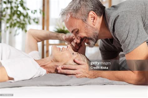 Mature Couple Having Romantic Moments In Bed High-Res Stock Photo