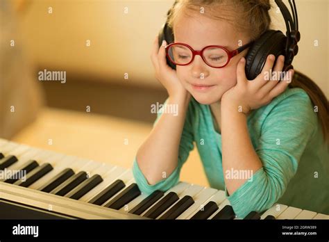 Girl with Down syndrome enjoys music Stock Photo - Alamy