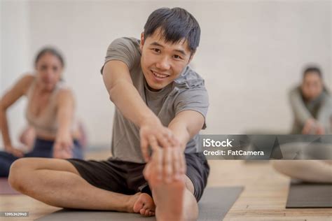 Stretching During Fitness Class Stock Photo - Download Image Now - 25 ...
