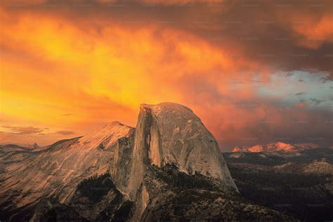 A very tall mountain with a very colorful sky in the background photo ...
