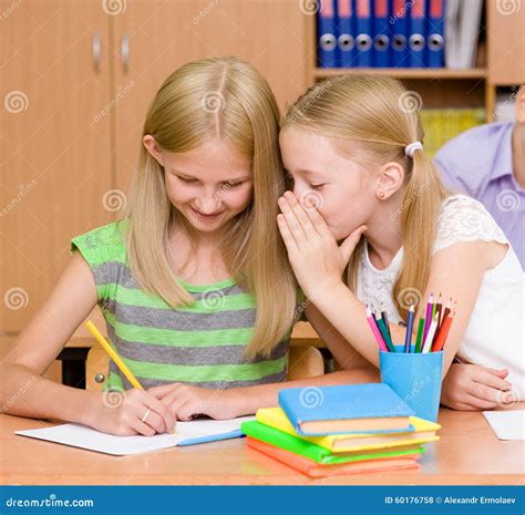 Girls Sharing Secrets in Classroom Stock Photo - Image of help