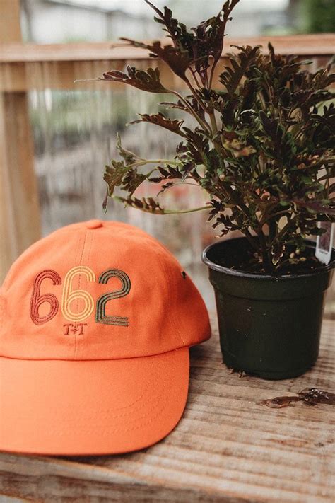 area code  orange hat tucked threaded