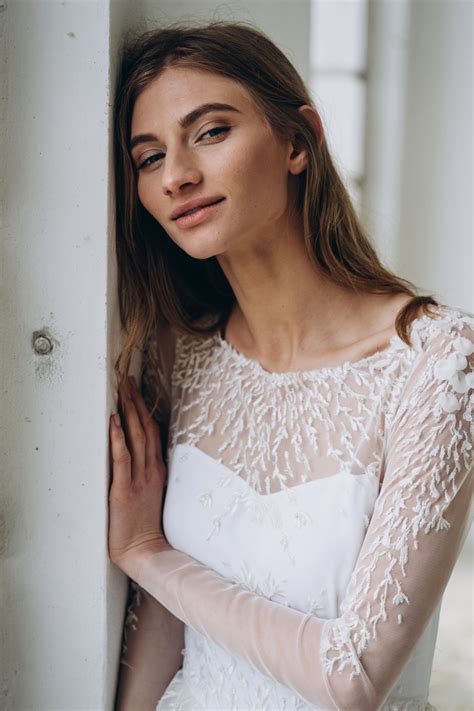 Off-white wedding dress with sheer long sleeve embroidered bodice