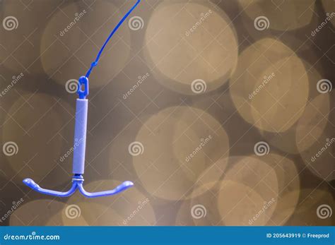 Holding an IUD Birth Control Copper Coil Device, Used for Contraception ...