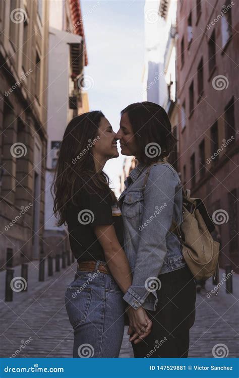 Attractive Young Women Lesbian Couple Kissing and Smiling in a Street ...