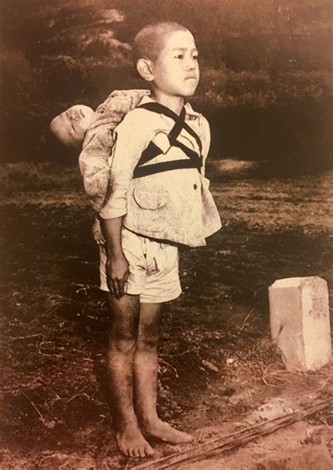 Japanese boy waiting in line at the crematorium with his deceased baby
