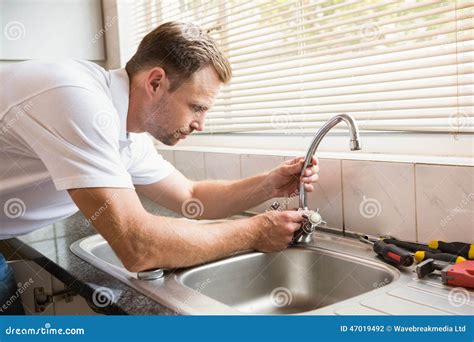 Man fixing tap with pliers stock photo. Image of home - 47019492