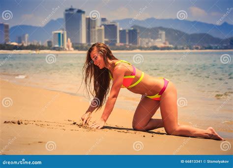 Blonde Slim Girl In Bikini Moves On Hands Knees Out Of Water Royalty