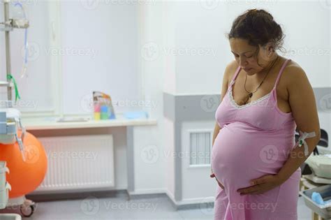 Pregnant woman birthing mother with painful contraction, touching belly