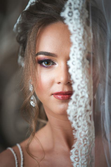 A beautiful bride poses, partially veiled. photo – Free Portrait Image