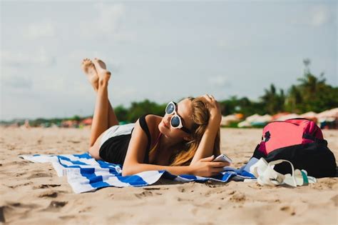 Premium Photo | Girl lying face down with sunglasses looking at the mobile