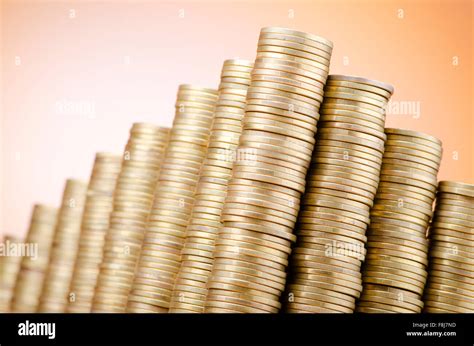 Golden coins in high stacks Stock Photo - Alamy