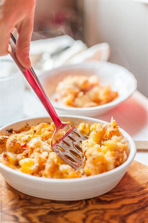 "Woman Serving Homemade Baked Pasta With Tomato Sauce" by Stocksy ...