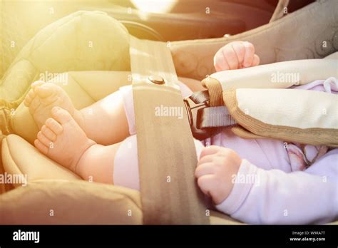Safety concept, protection of child in travel, children feet in baby ...