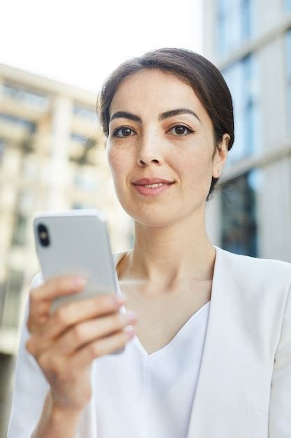 Premium Photo | Young Businesswoman Holding Smartphone