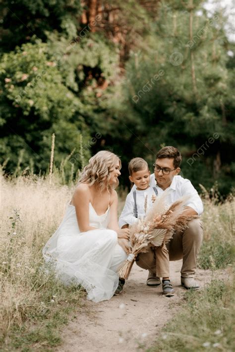 Happy Family Three Dad Mom And Son On A Walk In The Woods Photo