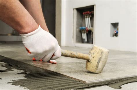 Premium Photo | Laying ceramic tiles.