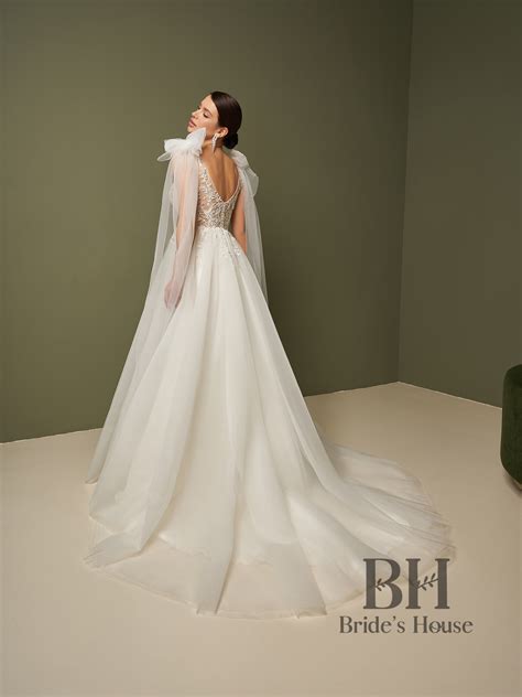 A-line wedding dress with semi-sheer bodice in nude, straps, open back