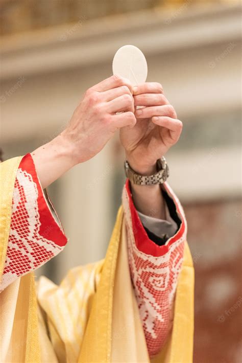 Premium Photo | The elevation of the sacramental bread during the ...