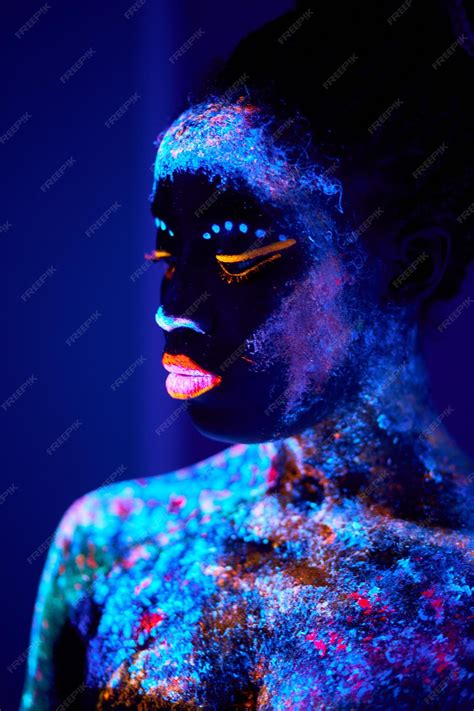 Premium Photo | Black female with uv body art glowing in darkness