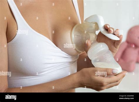 woman hands holding manual breast pump  expressing milk  feeding