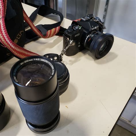 KONICA MINOLTA XD CAMERA W/ EXTRA LENSES AND BAG OF SUPPLIES - Big