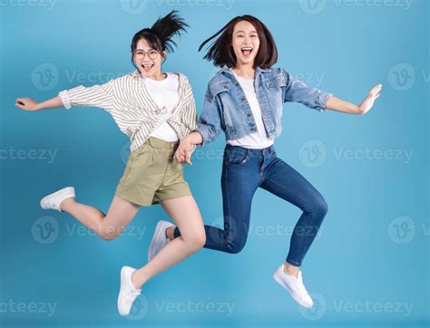 Two women on blue background 21393211 Stock Photo at Vecteezy