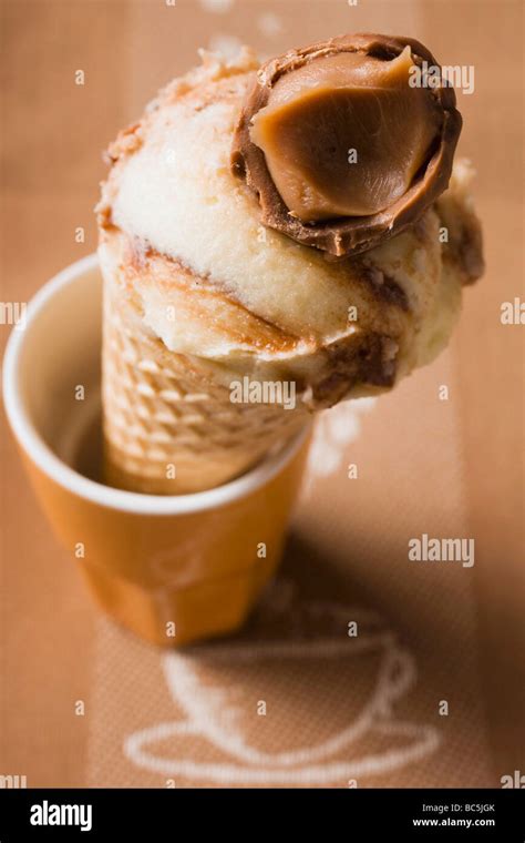 Caramel ice cream in wafer cone in a beaker Stock Photo - Alamy