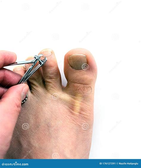 On the White Floor, a Person Cuts His Toenails Stock Image - Image of