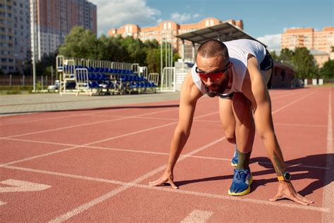 premium photo  man  ready  start  race   track