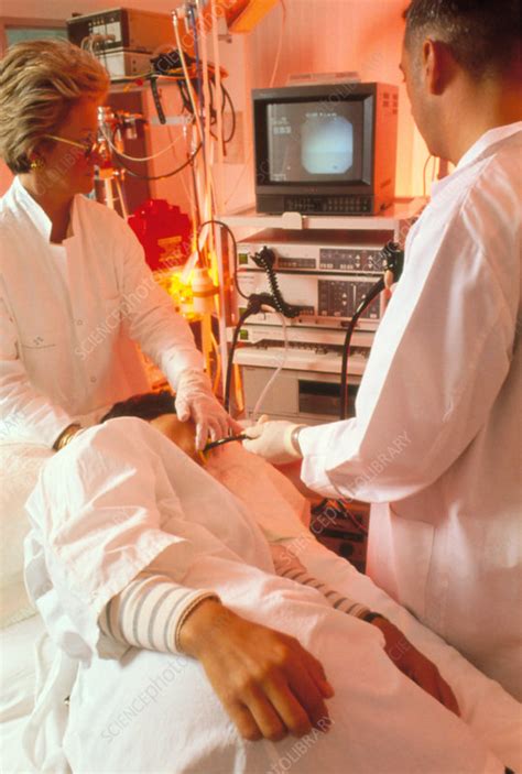 Surgeon examining woman's stomach using endoscope - Stock Image - M440 ...