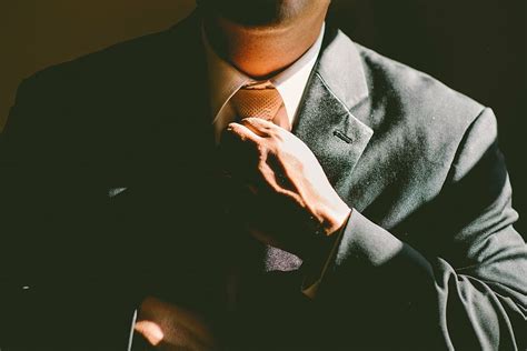 man black suit tie necktie adjust adjusting business cc