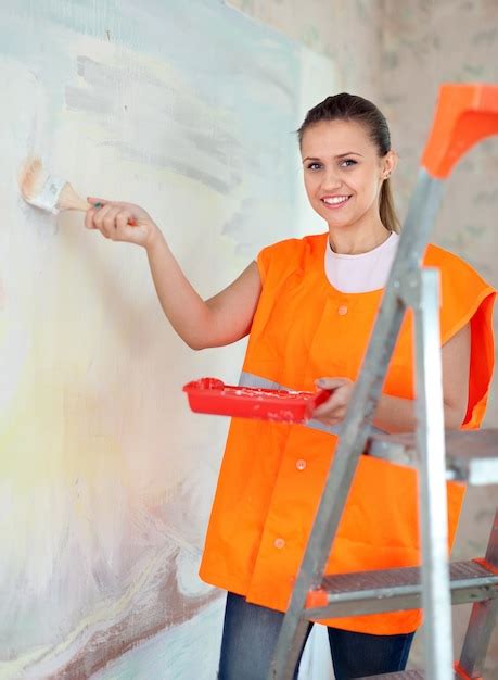photo house painter paints wall  brush