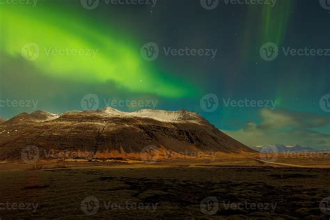 Icelandic slopes with northern lights forming amazing scenery under